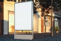 Blank illuminated white outdoor banner stand at evening time in the city, 3d rendering.