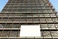 Blank information board hanging on the scaffoldings of the palace facade under construction. Bottom view