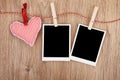 Blank instant photos and red heart hanging on the clothesline Royalty Free Stock Photo