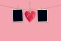 Blank instant photos and red heart hanging pastel color background. Royalty Free Stock Photo