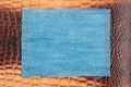 Blank jeans frame. Denim patch with orange thread seam on brown skin Royalty Free Stock Photo