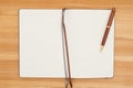 Blank journal with pen on a wood desk Royalty Free Stock Photo