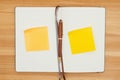 Blank journal with pen and  yellow sticky notes on a wood desk Royalty Free Stock Photo