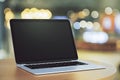 Blank laptop on bokeh background