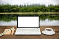 Blank laptop on wooden table