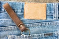 Blank leather jeans label on a blue jeans, wooden background. Royalty Free Stock Photo
