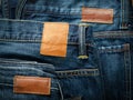 Blank leather jeans label sewed on a blue jeans. Jeans tag collection Royalty Free Stock Photo