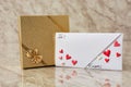 Blank letter envelope with gift box. Gift for Valentine`s Day. Royalty Free Stock Photo