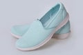 Blank light blue slip-on shoes on a white background. Plain hipster slipons.