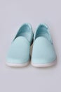 Blank light blue slip-on shoes on a white background. Plain hipster slipons.