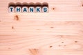 Blank light colored wood fills this template image with the word Thanks spelled out in blocks along the top