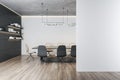 Blank light grey wall with empty place in modern meeting room with bookshelves on dark wall, stylish conference table surrounded