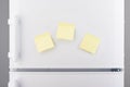 Blank light yellow sticky paper notes on white refrigerator Royalty Free Stock Photo