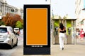 blank lightbox ad panel along sidewalk. outdoor advertising sign panel. parked cabs and pedestrians Royalty Free Stock Photo