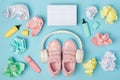 Blank lightbox. Headphones, pink shoes, colored crumpled paper balls, marker on blue background. Education concept. Flat