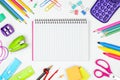 Blank, lined, notebook with school supplies frame against white with copy space. Back to school. Royalty Free Stock Photo