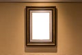 The blank luxury photo frame hanging on the brown wall interior