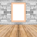 Blank maize wooden photo frame leaning at white brick wall. Royalty Free Stock Photo