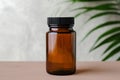 Blank medical bottle mockup for pills. Transparent dark bottle of amber glass with green plant. Herbal medicine concept