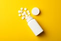 Blank medical bottle and pills on yellow background Royalty Free Stock Photo