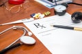 Blank medical prescription with stethoscope, pills, pen Royalty Free Stock Photo