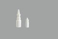 Blank Medicine bottle. White plastic medical containers for nasal spray (decongestant) on gray background  mockup. Royalty Free Stock Photo