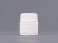 Blank medium size medicine white plastic packaging bottles for cosmetics, vitamins, pills or capsules. Packaging on gray