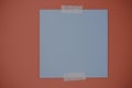 Blank memo square note on red background. Blank blue colored memo notes with ripped decorative adhesive washi tapes on Royalty Free Stock Photo
