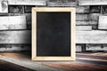 Blank menu blackboard leaning at plank wood wall and diagonal wood floor,Mock up for adding your design Royalty Free Stock Photo