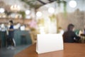 Blank menu frame label mockup. Menu frame mockup n wooden table in bar restaurant, stand for booklet with white sheet of acrylic Royalty Free Stock Photo