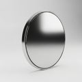 Blank metallic silver coin or disc with a polished reflective surface on a white background Royalty Free Stock Photo