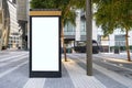 Electronic modern empty scoreboard on the background of a city street. Blank mock up of vertical street poster billboard on city