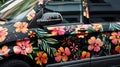 Blank mockup of a floral vehicle decal for a company car showcasing a pattern of colorful flowers and company branding.