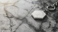 Blank mockup of a marble keychain with a blank hexagonal pendant for customization.