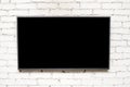 Blank modern flat screen TV at the light brick wall with copyspace for your text, plasma TV Royalty Free Stock Photo