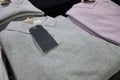 Blank multi colored collared t-shirts with labels at store counter