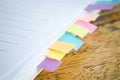 Blank note book with colorfull post it on wood table Royalty Free Stock Photo