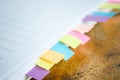 Blank note book with colorfull post it on wood table Royalty Free Stock Photo