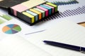 Blank note book with financial graph, attach memo and pen Royalty Free Stock Photo