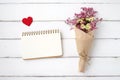 Blank note book paper, fabric heart shape and flower bouquet on Royalty Free Stock Photo