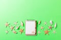 Blank note book with starfish or seashells on a green background , summer vaction concept