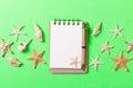 Blank note book with starfish or seashells on a green background , summer vaction concept