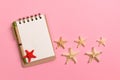 Blank note book with starfish or seashells on a pink background , summer vaction concept Royalty Free Stock Photo