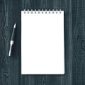 Blank note pad and pen on wooden table Royalty Free Stock Photo