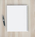 Blank note pad and pen on wooden table Royalty Free Stock Photo