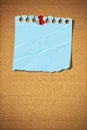 Blank note paper with pin on cork board Royalty Free Stock Photo