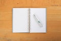 Blank note and pen on wooden table. Royalty Free Stock Photo