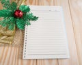 Blank notebook with chrismas ribbon on wood background Royalty Free Stock Photo