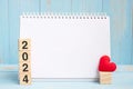 blank notebook and 2024 cubes with red heart shape decoration on blue wooden table background. New Year NewYou, Goal, Resolution, Royalty Free Stock Photo