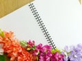 Blank notebook diary with artificial flower on wooden background Royalty Free Stock Photo